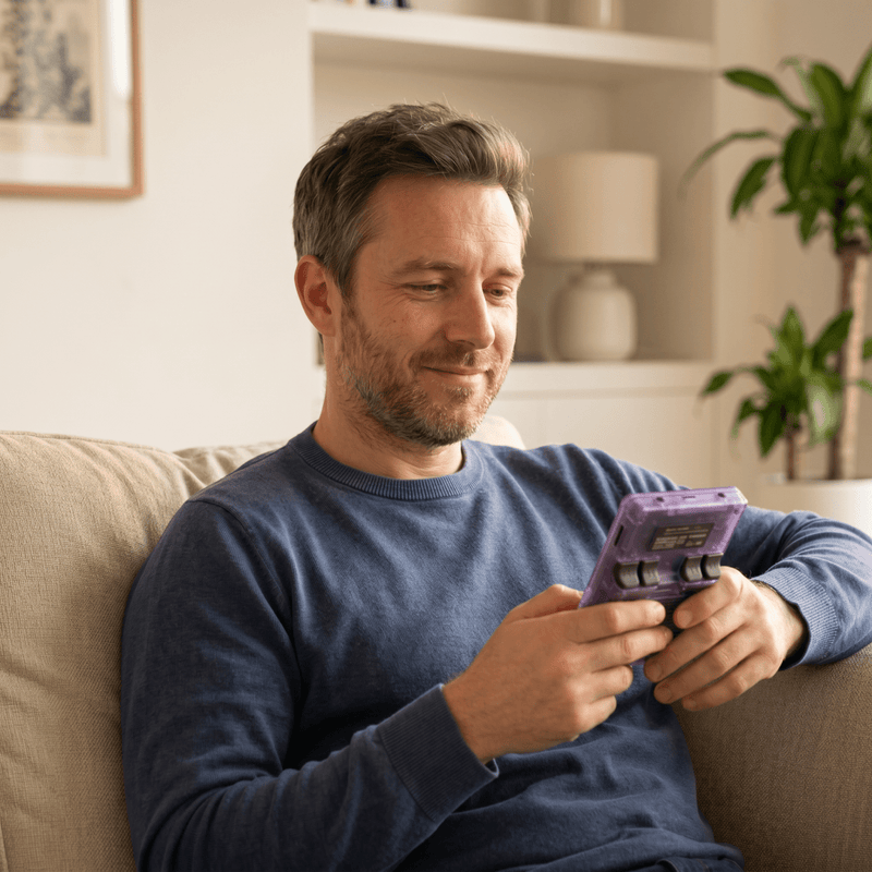 Person playing the Tkhotpick Pro 2.0 R36S retro gaming console at home